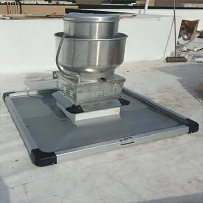 Close up of rooftop grease containment pads on a commercial kitchen fan