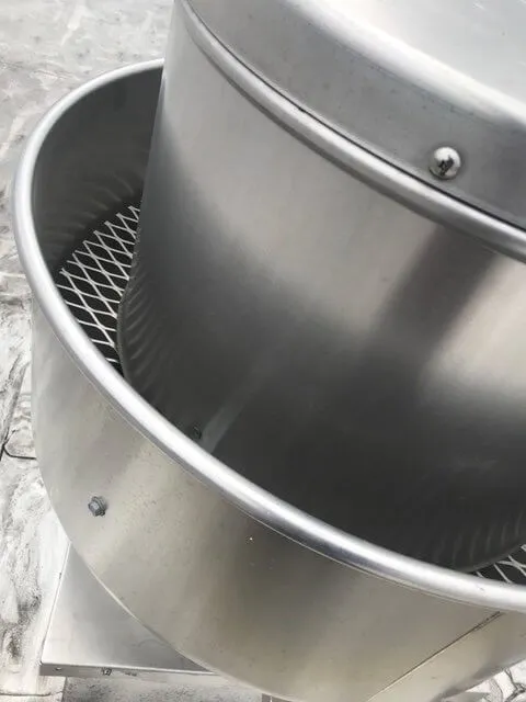 Raleigh Hood Cleaning Pros technician inspecting a rooftop grease containment system